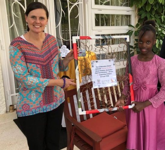 Grace, one of our students, handing over a gift to the former Australian High Commissioner to Kenya